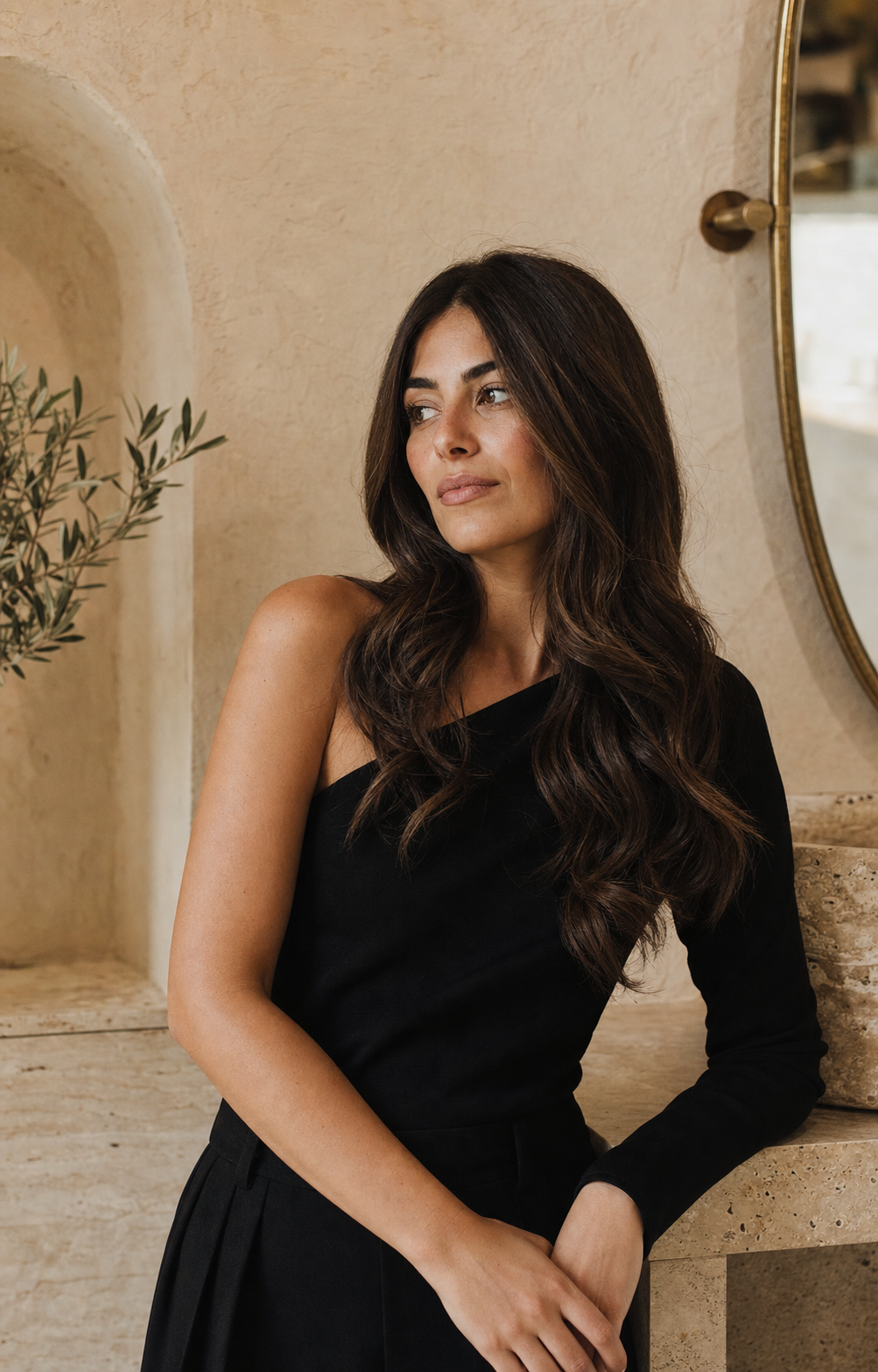 Donna con lunghi capelli castani mossi in un elegante atelier